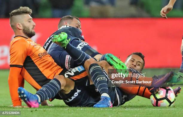 Brandon Borrello of the Roar and Daniel Georgievski and Leigh Broxham of the Victory compete for the ball during the A-League Semi Final match...