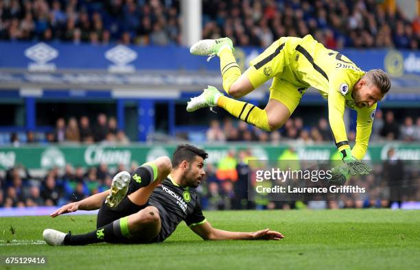Diego Costa of Chelsea fouls Maarten Stekelenburg of Everton during the Premier League match between Everton and Chelsea at Goodison Park on April...