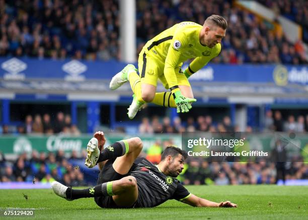 Diego Costa of Chelsea fouls Maarten Stekelenburg of Everton during the Premier League match between Everton and Chelsea at Goodison Park on April...