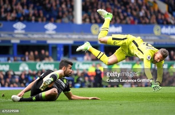 Diego Costa of Chelsea fouls Maarten Stekelenburg of Everton during the Premier League match between Everton and Chelsea at Goodison Park on April...