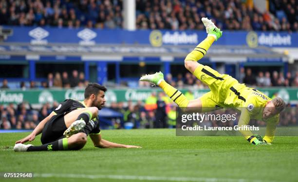 Diego Costa of Chelsea fouls Maarten Stekelenburg of Everton during the Premier League match between Everton and Chelsea at Goodison Park on April...