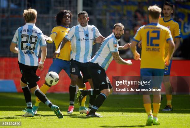 Stefan Aigner, Amilton and Sascha Moelders of Muenchen fight for the Ball with Saulo Decarli of Braunschweig during the Second Bundesliga match...