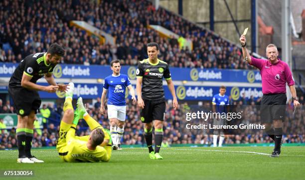 Referee Jonathan Moss shows Diego Costa of Chelsea a yellow card for a challenge on Maarten Stekelenburg of Everton during the Premier League match...