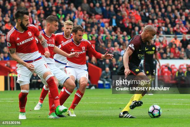 Manchester City's Belgian defender Vincent Kompany turns away from the Middlesborough defence including Middlesbrough's Spanish striker Alvaro...