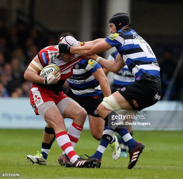Ben Morgan of Gloucester is held by Luke Charteris during the Aviva Premiership match between Bath and Gloucester at the Recreation Ground on April...