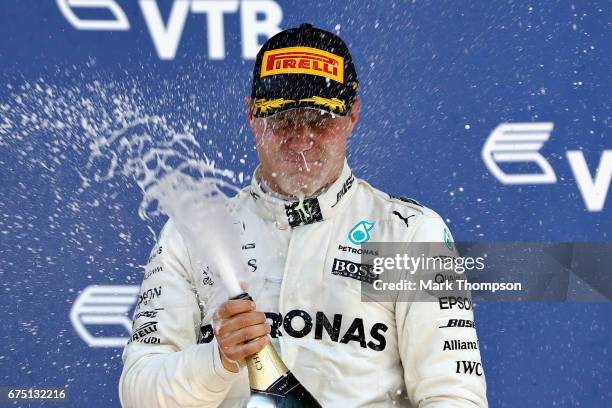 Race winner Valtteri Bottas of Finland and Mercedes GP celebrates on the podium during the Formula One Grand Prix of Russia on April 30, 2017 in...