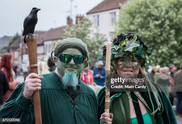 People gather to watch the Glastonbury Dragons being paraded through the town as part of the Glastonbury Dragon's May Fayre which is part of the...