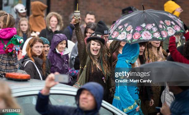 People follow as the Glastonbury Dragons are paraded through the town as part of the Glastonbury Dragon's May Fayre which is part of the town's...