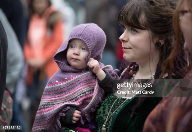 People gather to watch the Glastonbury Dragons being paraded through the town as part of the Glastonbury Dragon's May Fayre which is part of the...