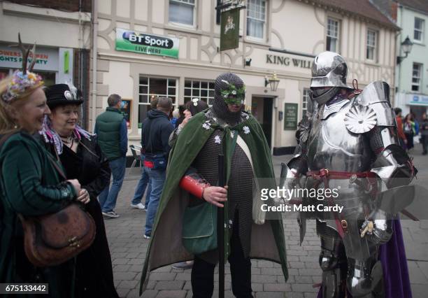 People gather to watch the Glastonbury Dragons being paraded through the town as part of the Glastonbury Dragon's May Fayre which is part of the...