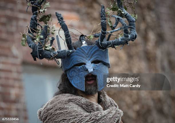 Performers entertain the crowd ahead of the Glastonbury Dragons being paraded through the town as part of the Glastonbury Dragon's May Fayre which is...