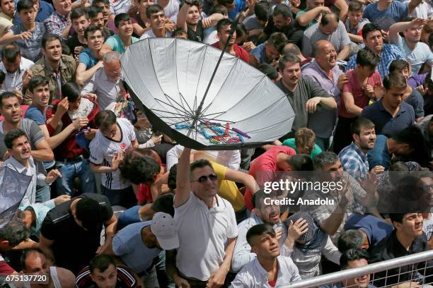 People try to catch Mesir pastes during the 477th International Manisa Mesir Paste Festival hein Manisa, the Aegean region, Turkey, April 30, 2017....