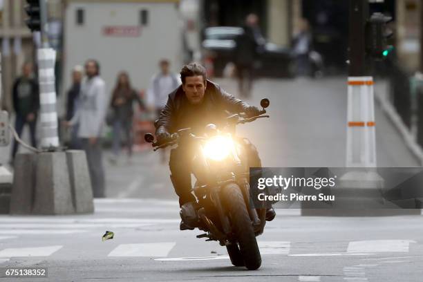 Actor Tom Cruise is seen riding a BMW bike on the set of 'Mission Impossible 6 Gemini' on Avenue de l'Opera on April 30, 2017 in Paris, France.