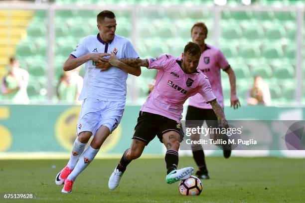 Alessandro Diamanti of Palermo is challenged by Josip Ilicic of Fiorentina during the Serie A match between US Citta di Palermo and ACF Fiorentina at...