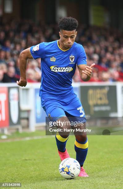 Lyle Taylor of A.F.C. Wimbledon runs with the ball during the Sky Bet League One match between A.F.C Wimbledon and Oldham Athletic at The Cherry Red...