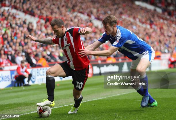 Billy Sharp, Captain of Sheffield United is challenged by Tom Anderson of Chesterfield during the Sky Bet League One match between Sheffield United...