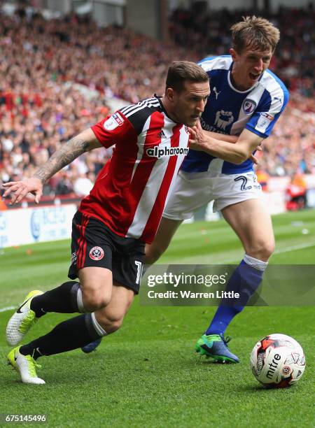 Billy Sharp, Captain of Sheffield United is challenged by Tom Anderson of Chesterfield during the Sky Bet League One match between Sheffield United...