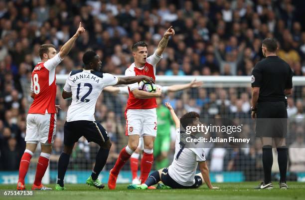 Aaron Ramsey of Arsenal, Victor Wanyama of Tottenham Hotspur, Granit Xhaka of Arsenal and Alexis Sanchez of Arsenal all appeal to referee Michael...