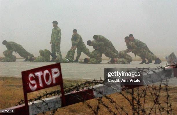 Nepalese Army soldiers exercise during the early morning December 3, 2001 before patrolling the streets of Kathmandu, Nepal. The Nepalese government...