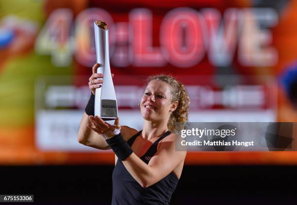 Laura Siegemund of Germany celebrates with the trophy after the singles final match against Kristina Mladenovic of France on Day 7 of the Porsche...
