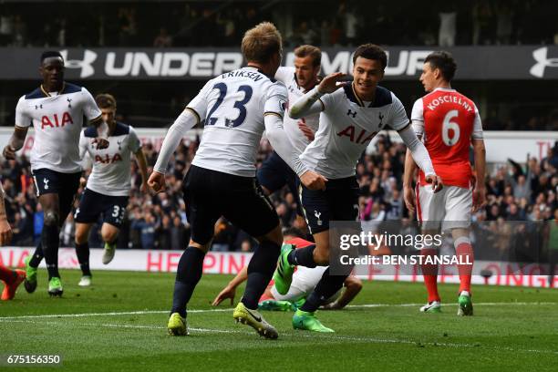 Tottenham Hotspur's English midfielder Dele Alli celebrates scoring the opening goal with Tottenham Hotspur's Danish midfielder Christian Eriksen...