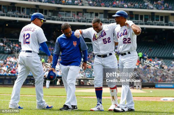 Juan Lagares of the New York Mets replaces Yoenis Cespedes as he is heped off the field after an injury against the Atlanta Braves by trainer Ray...