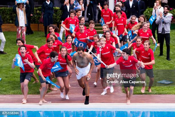 Rafael Nadal of Spain dives in the swimming pool with ballboys after his victory against Dominic Thiem of Austria in their final match on day seven...