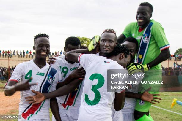 South Sudan's players embrace their captain James Joseph Moga after he scored the second goal during the first round African Nations Championship...