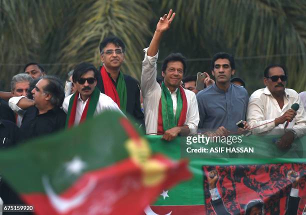 Pakistan opposition leader Imran Khan waves to supporters as he leads a protest rally in support of the citizens in Karachi on April 30, 2017....