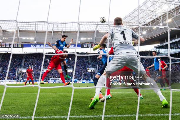 Benjamin Huebner of Hoffenheim scores his team's first goal with a header past Lukas Hradecky of Frankfurt during the Bundesliga match between TSG...