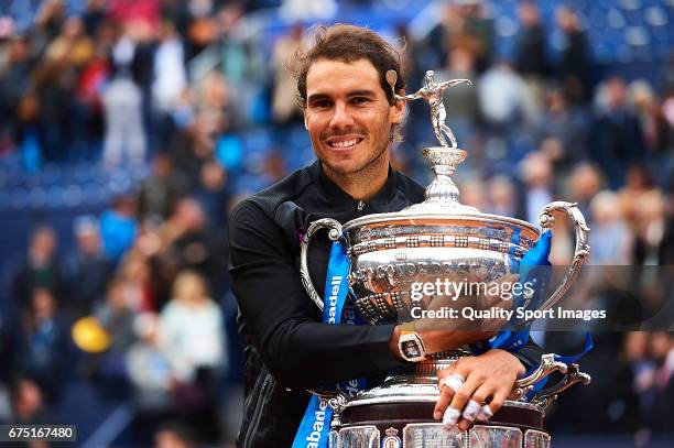 Rafael Nadal of Spain celebrates with the trophy after winning his match against Dominic Thiem of Austria during the Day 6 of the Barcelona Open Banc...