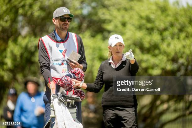 Cristie Kerr of the United States discusses her tee shot on the second hole with caddie Brady Stockton during the final round of the Volunteers of...