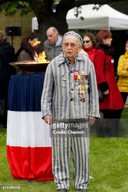 The former deportee, Jean Villeret poses in prisoner's uniform in the garden of the "Memorial des Martyrs de la Deportation" on April 30, 2017 in...