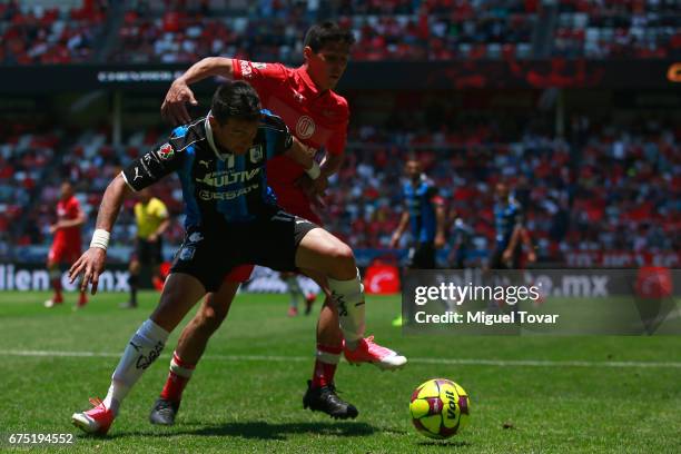 Pablo Barrientos of Toluca fights for the ball with Edgar Benitez of Queretaro during the 16th round match between Toluca and Queretaro as part of...