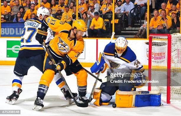 Goalie Jake Allen of the St. Louis Blues makes a save against Colin Wilson of the Nashville Predators during the first period in Game Three of the...