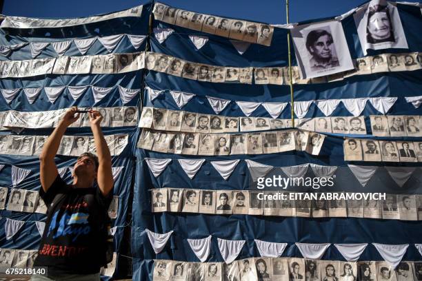 Man takes a selfie next to portraits of victims of forced disappearance in the Plaza de Mayo square in Buenos Aires, Argentina, on April 30 during...