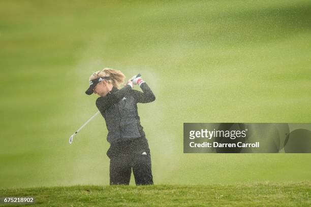 Jessica Korda of the United States reacts to wind-blown sand after playing her second shot at the ninth hole during the final round of the Volunteers...