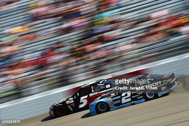 Brad Keselowski, driver of the Detroit Genuine Parts Ford, races Kasey Kahne, driver of the AARP Drive to End Hunger Chevrolet, during the Monster...