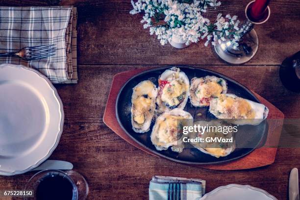 eating baked oysters au gratin - gratin stock pictures, royalty-free photos & images