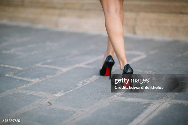 May Berthelot, Head of Legal at Videdressing.com and fashion blogger, wears a Harpe black meshed blouse, a Topshop ruffled black skirt, Louboutin...