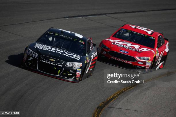 Kasey Kahne, driver of the AARP Drive to End Hunger Chevrolet, leads Clint Bowyer, driver of the Haas Automation Demo Days Ford, during the Monster...