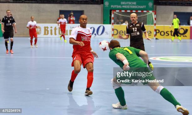 Goalkeeper Kamil Dworzecki of Hohenstein-Ernstthal challenges Marcus Vinicius Da Silva Lima of Jahn Regensburg during the Deutsche Futsal...