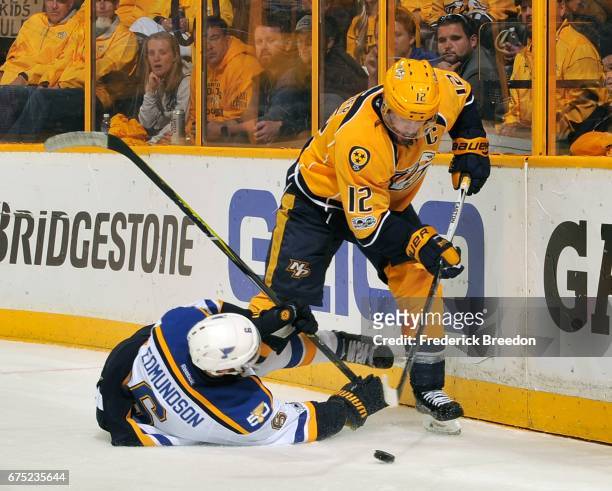 Mike Fisher of the Nashville Predators skates past Carl Gunnarsson of the St. Louis Blues during the third period in Game Three of the Western...