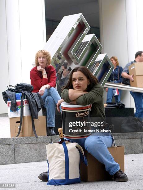 Meredith Stewart , who worked in Enron's networking/data processing department, sits on her personal belongings in front of the company's...