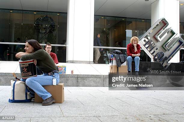 Meredith Stewart , who worked in Enron's networking/data processing department, sits on her personal belongings in front of the company's...