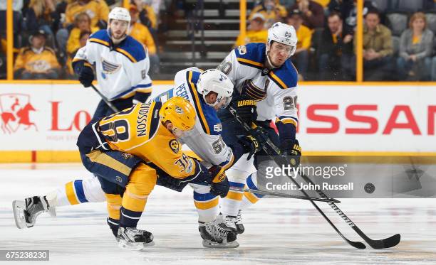 Viktor Arvidsson of the Nashville Predators battles for the puck against David Perron and Alexander Steen of the St. Louis Blues in Game Three of the...