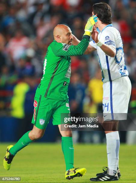 Oscar Perez goalkeeper of Pachuca celebrates with teammate Omar Gonzalez after scoring the second goal of his team during a match between Pachuca and...