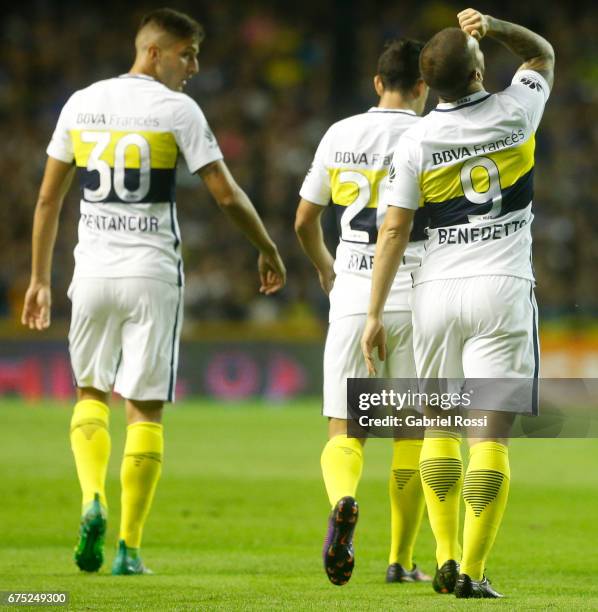 Dario Benedetto of Boca Juniors celebrates with teammates Rodrigo Bentancur and Gonzalo Maroni after scoring the first goal of his team during a...