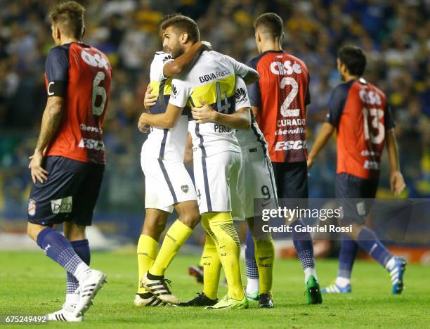 Dario Benedetto of Boca Juniors celebrates with teammates Gino Peruzzi and Rodrigo Bentancur after scoring the second goal of his team during a match...