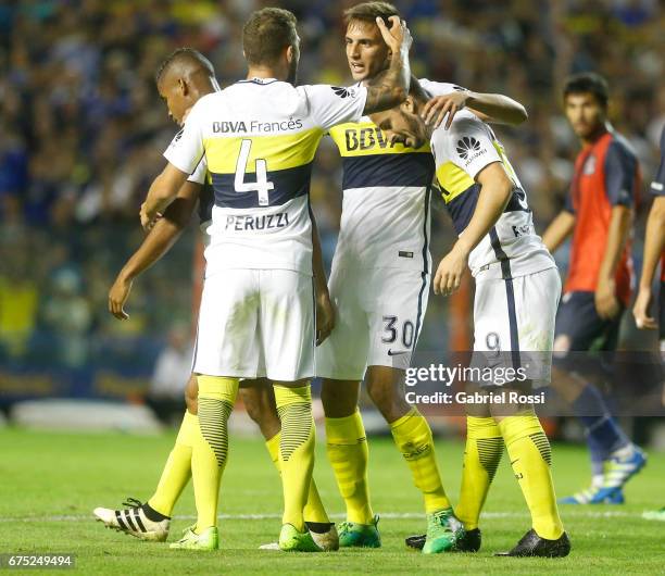 Dario Benedetto of Boca Juniors celebrates with teammates Gino Peruzzi and Rodrigo Bentancur after scoring the second goal of his team during a match...